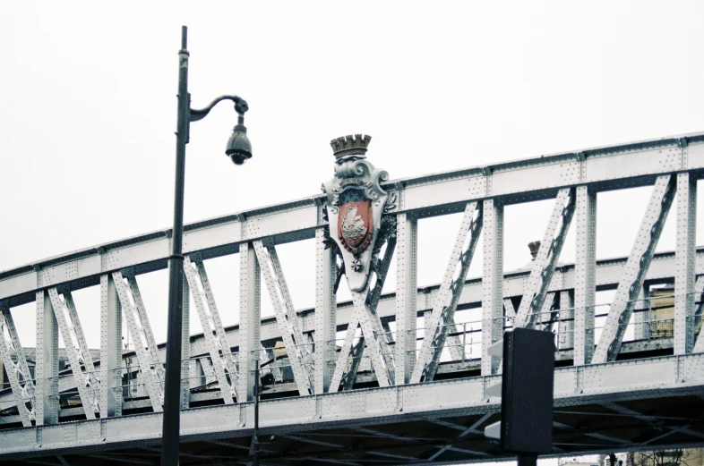 a white bridge with a large crest and crown on the end