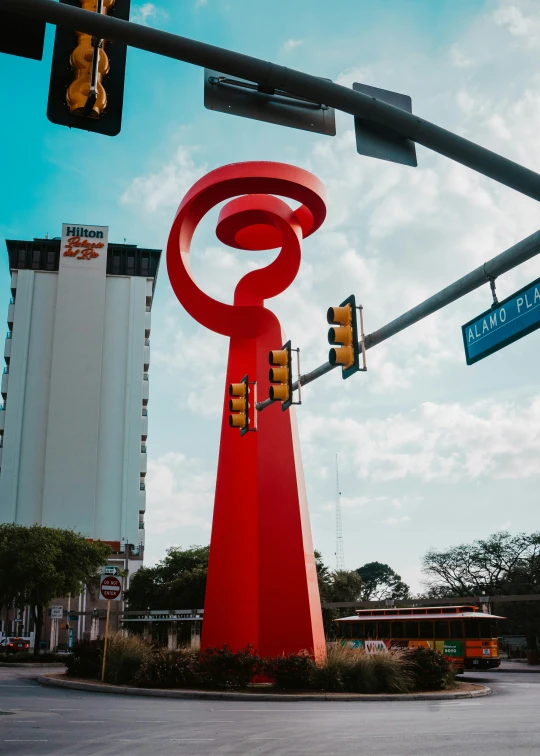 there is a large sculpture with a street sign on it