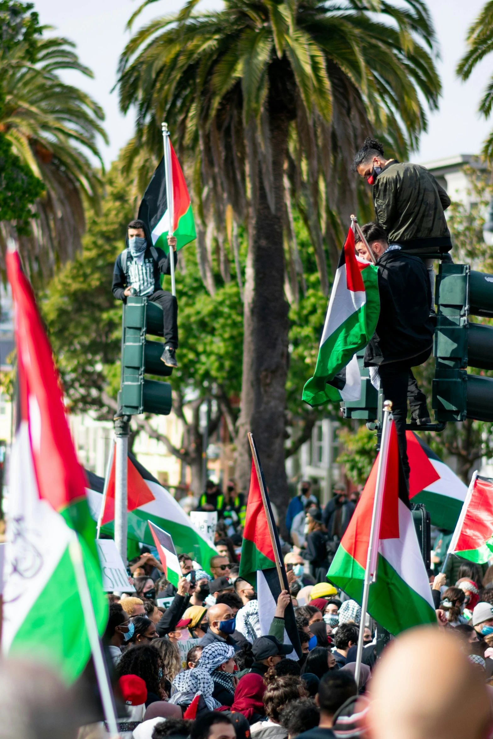 people on street with flags and green and red