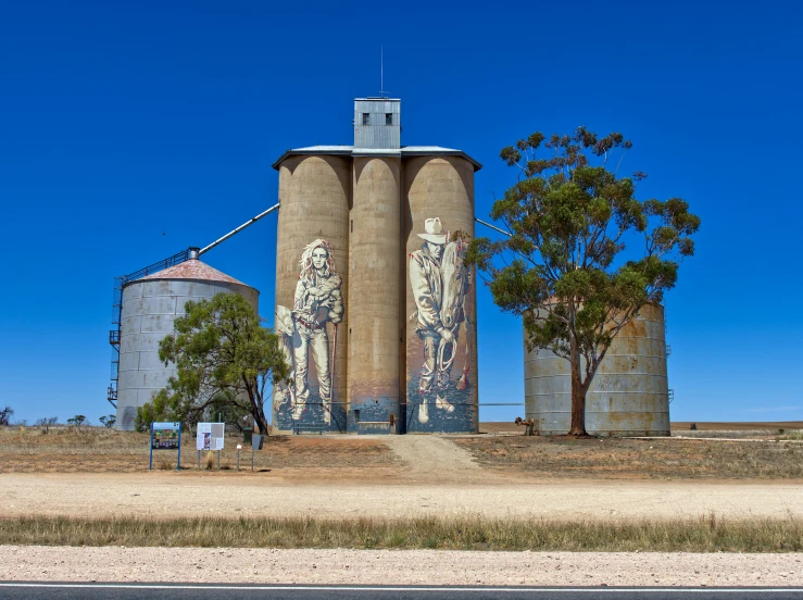 a tall silo sitting in the middle of a field