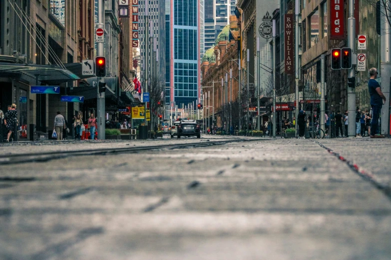 a city street with cars, buildings and tall buildings