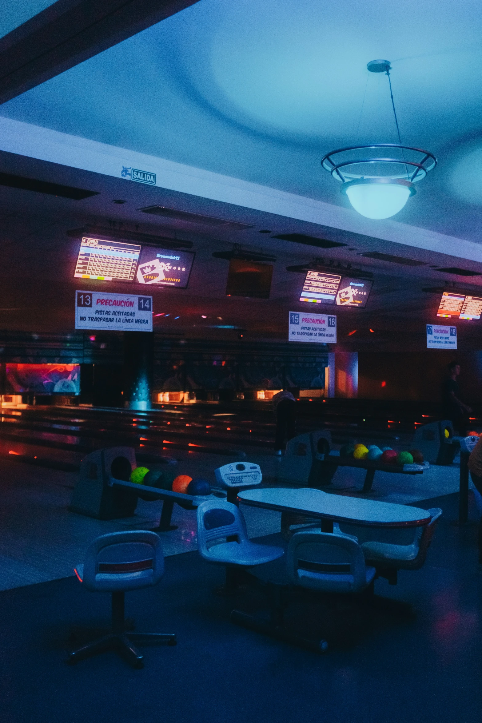 a bowling alley is lit up at night