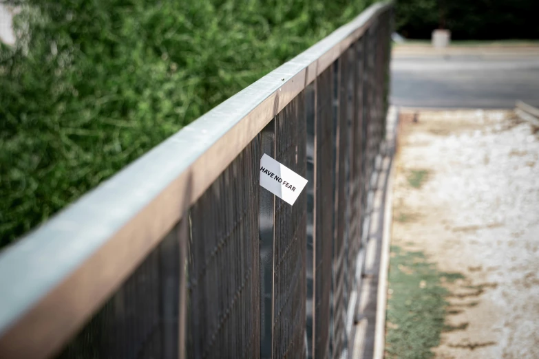 this is an image of a fence with a card that reads, on it
