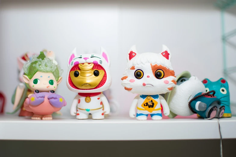 small little animals standing on a shelf together