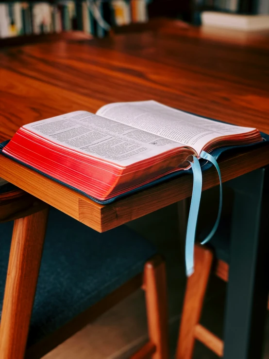 an open book sitting on top of a wooden table