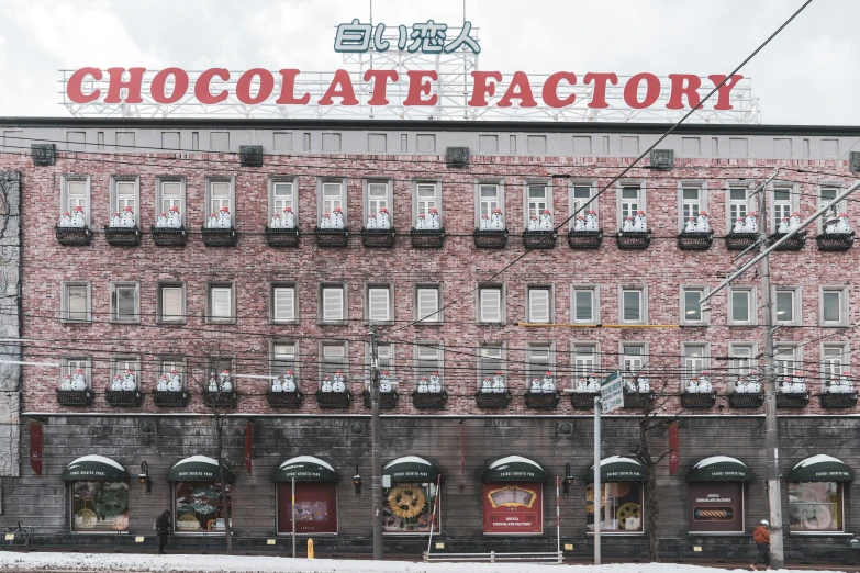 an old brick building with windows and a giant sign