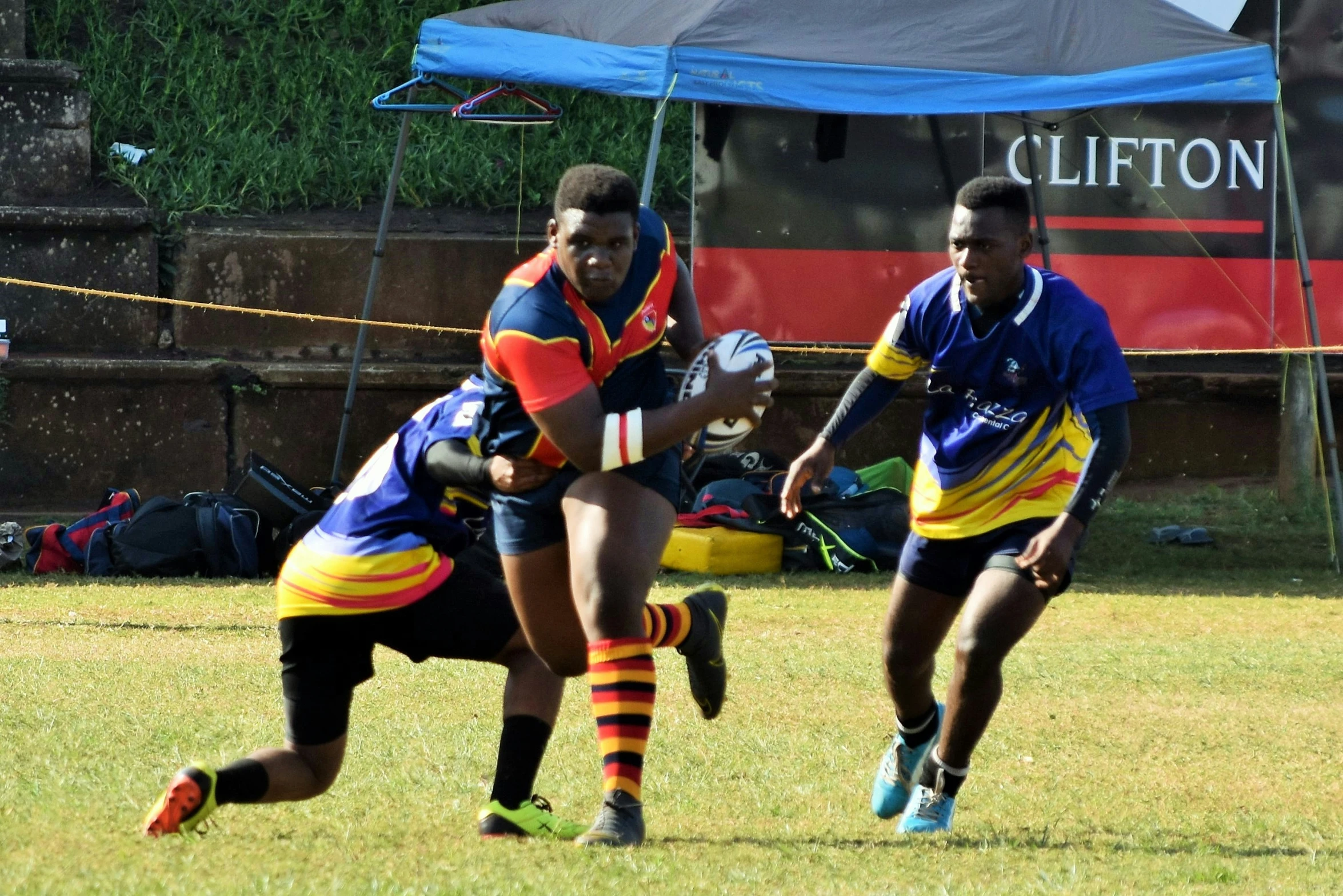 two people playing rugby in the field