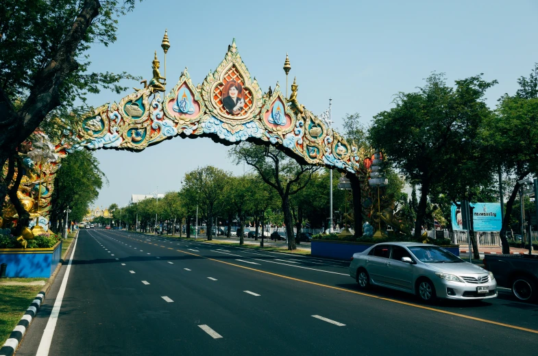 a road that has a fancy gate with decorations on it