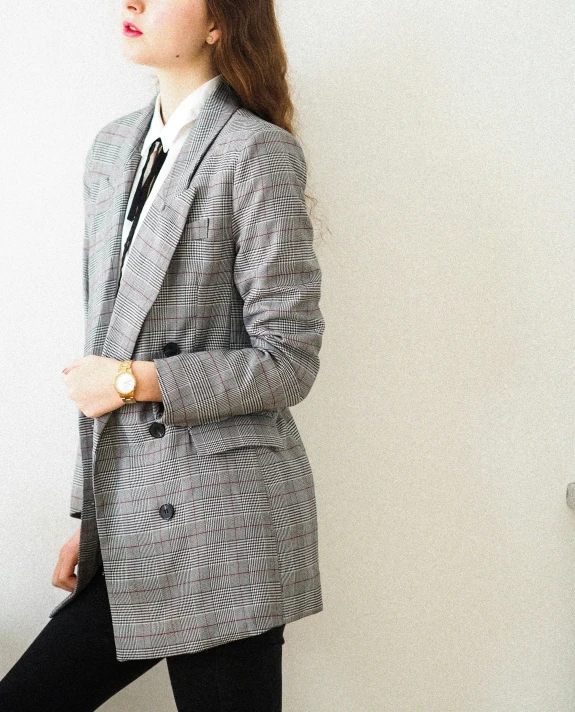 a woman in a business suit poses for a po