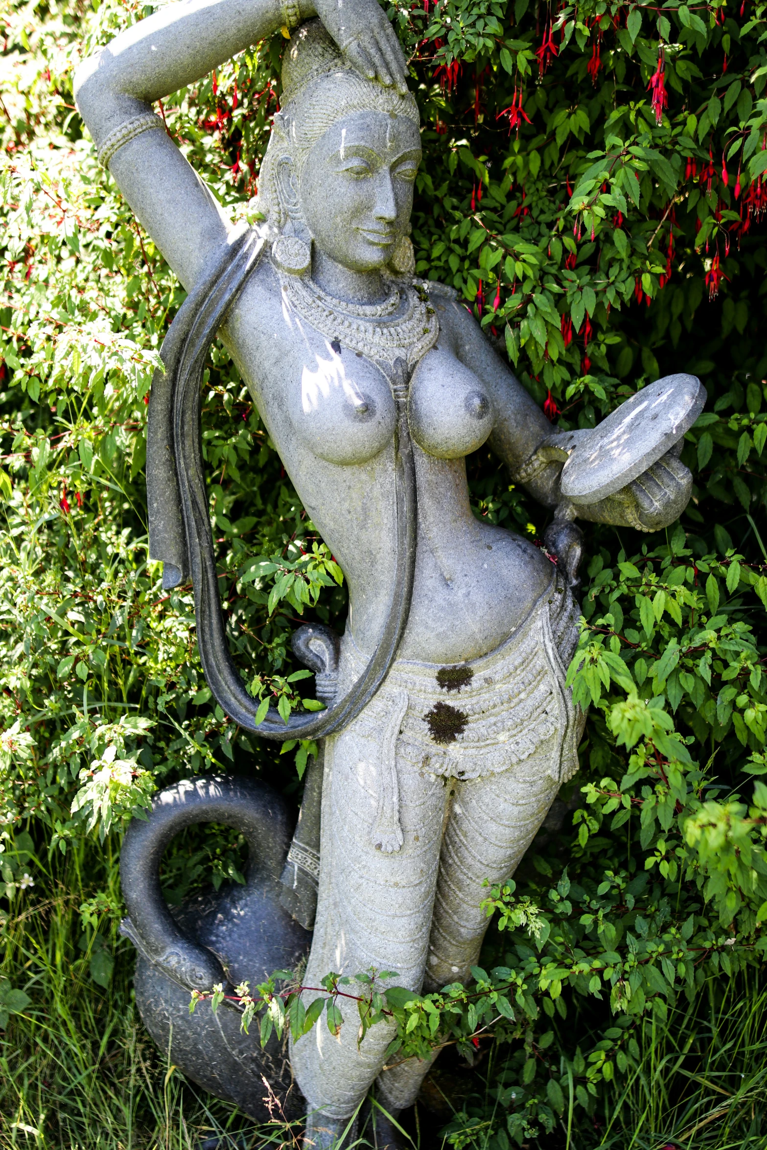 a statue is holding a hose and drinking water