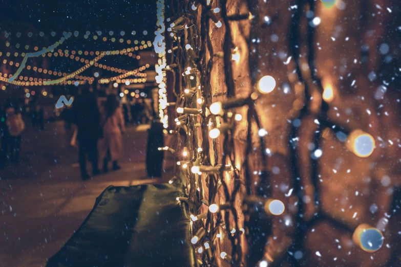 a large tree is covered with lights and snow