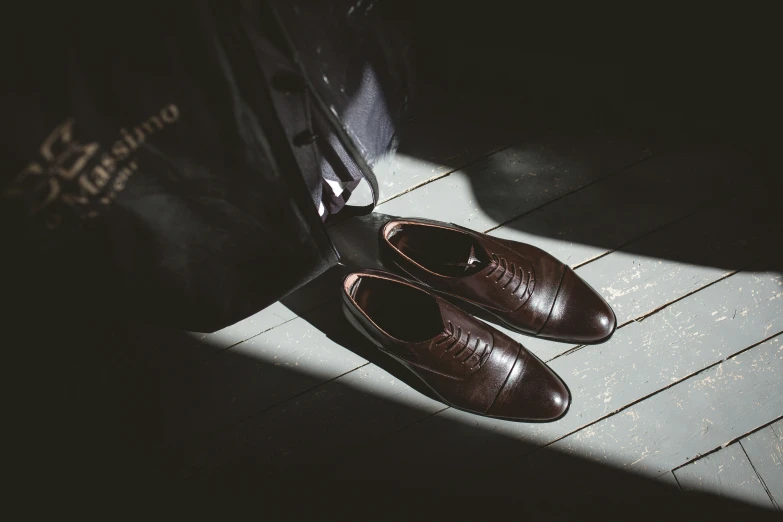 a pair of shoes sit on a wooden floor