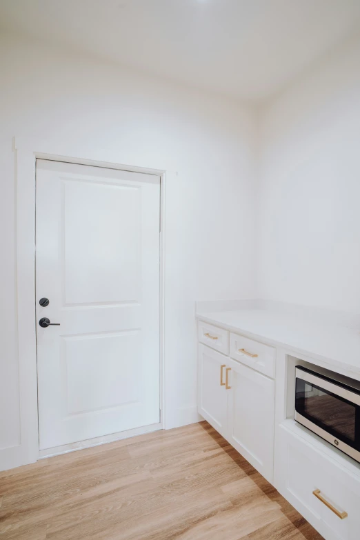 this is a small room with a door and a white wall