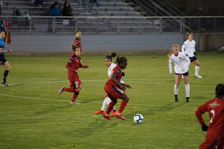 a group of young women playing a game of soccer