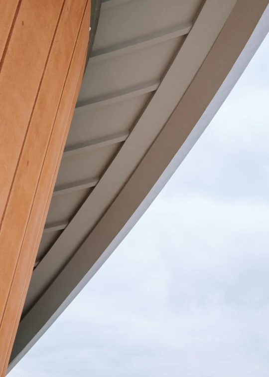 a brown building with a bird flying over it's roof