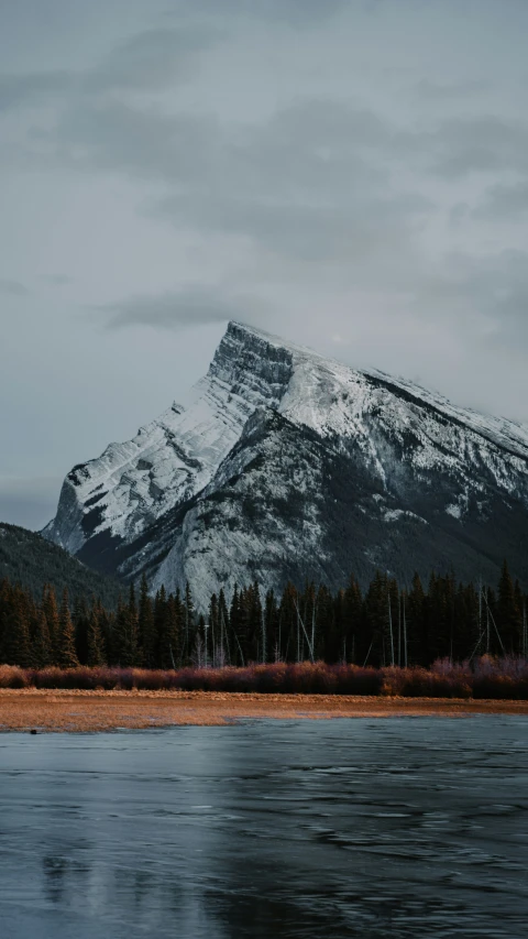 the snowy mountains on the water are covered with snow