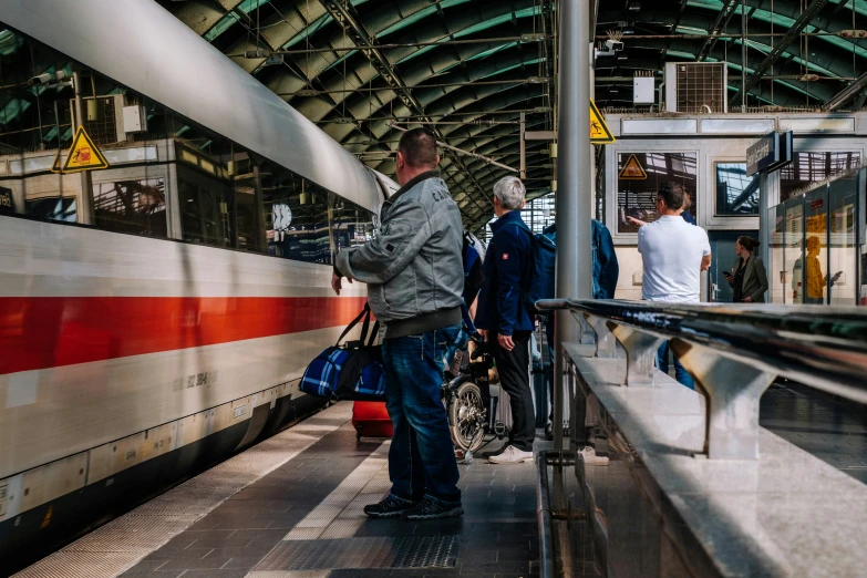 men standing by a subway station on the platform