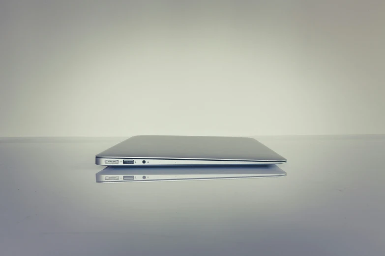 an open laptop computer sitting on top of a glass table