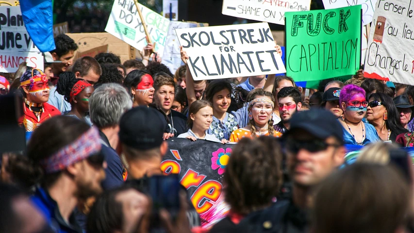 a group of people holding signs with the word