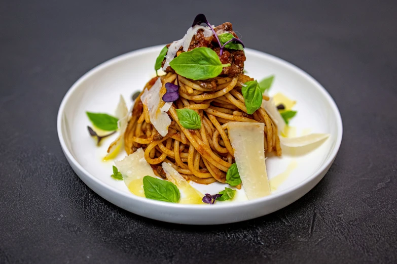 some noodles with various toppings in a white bowl