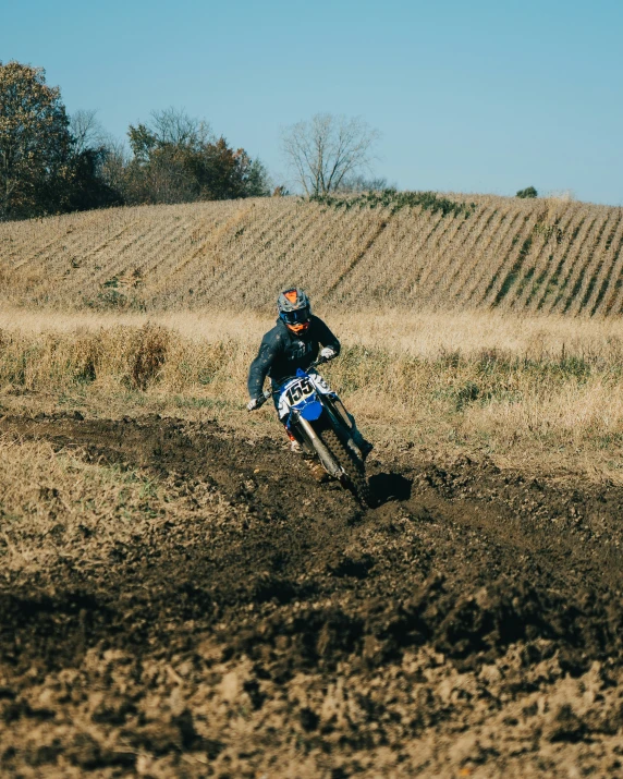 a man riding a motorcycle on top of a dirt trail