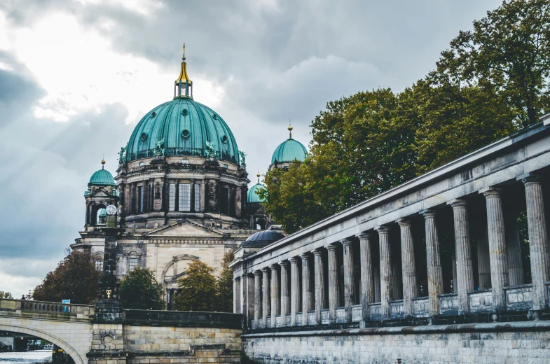 an old bridge leading to a domed building