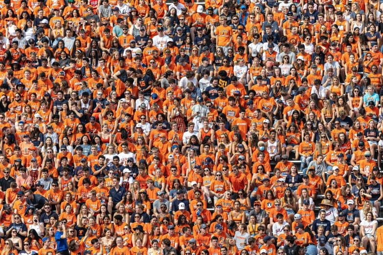 an audience of people wearing orange shirts