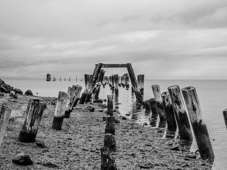 an old, wrecked pier on the water