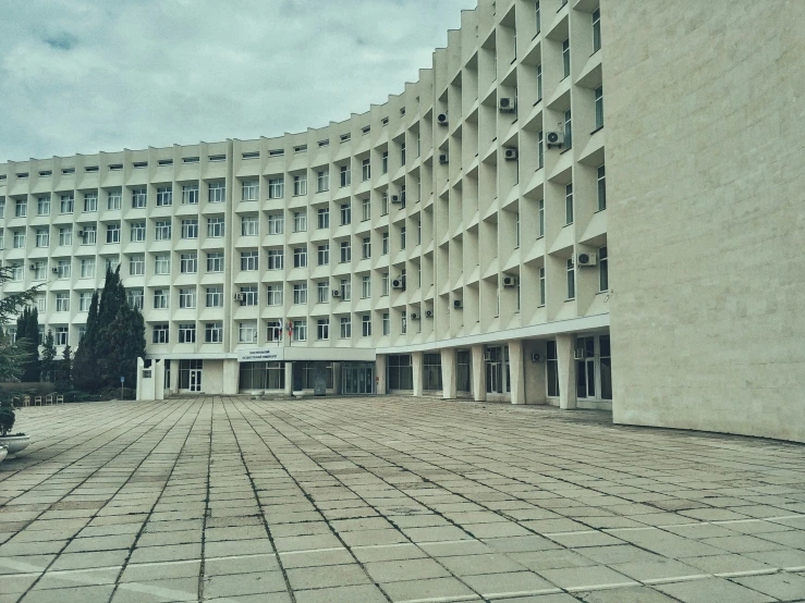 a circular building sitting next to a tree