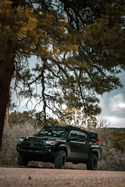 two pick - up trucks parked side by side on a country road