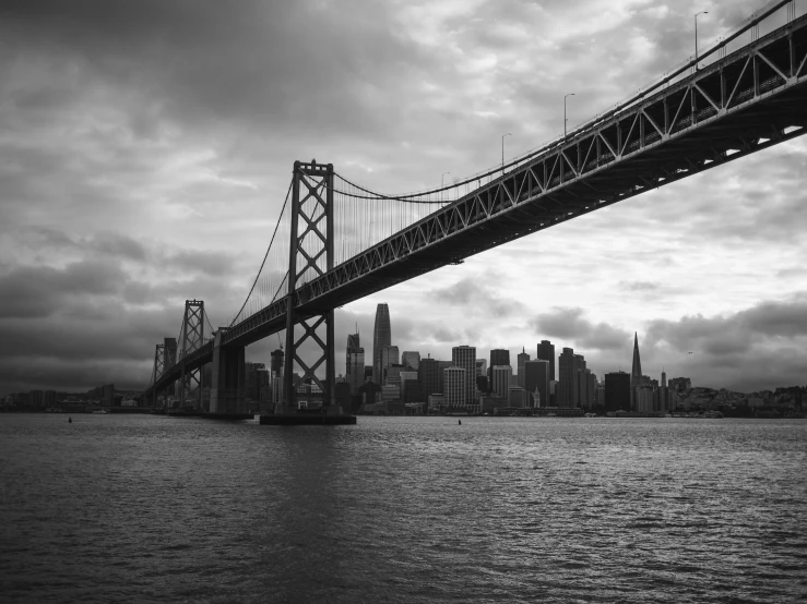 a black and white po of a bridge over a body of water