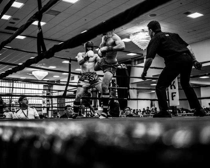 a boxing match being attended in a dark place