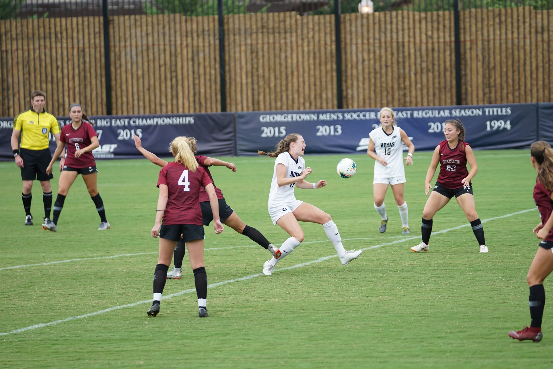 some female soccer players are playing on the field