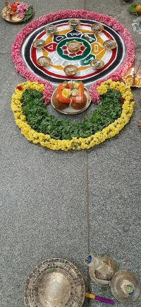 a circle shaped decoration made of flowers with a statue