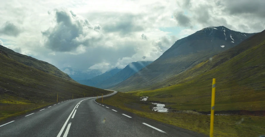 an empty highway on the side of the mountain pass