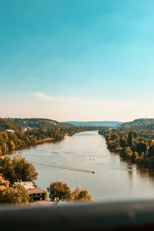 looking over a body of water at a lush green countryside