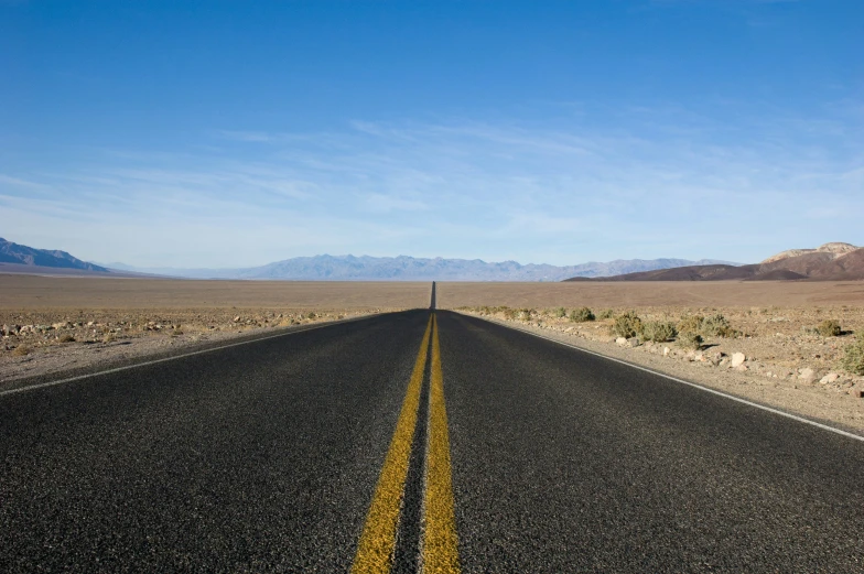 the highway is empty and in a desert environment