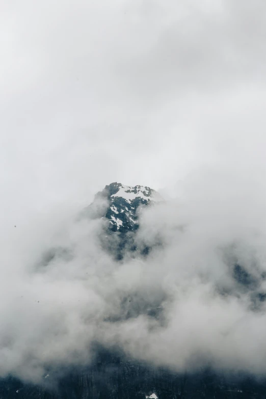 a foggy mountain range that has been covered in thick clouds