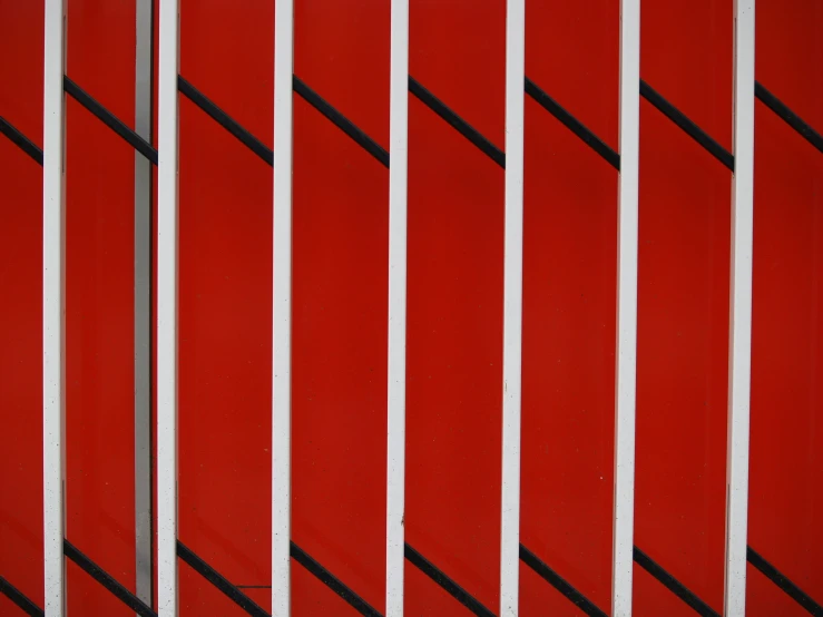 a red and white wall with horizontal stripes