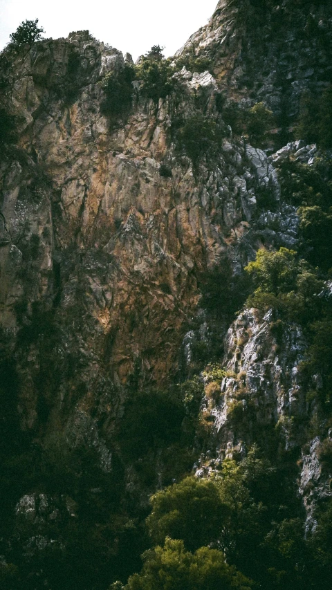 a mountain side with large rocks on the top