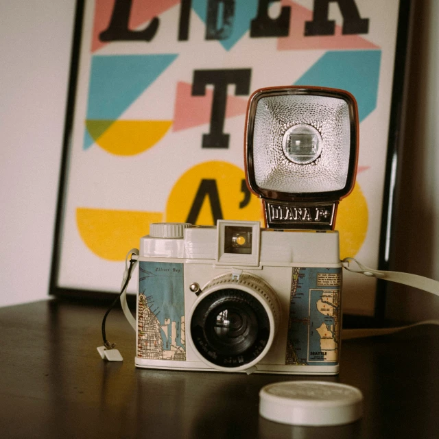 a vintage camera sitting on top of a wooden table