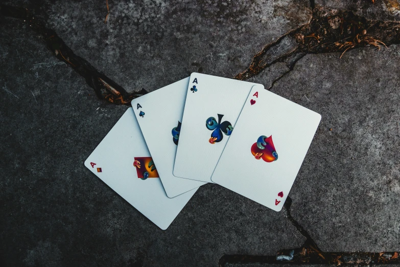 playing cards lying on a gray surface