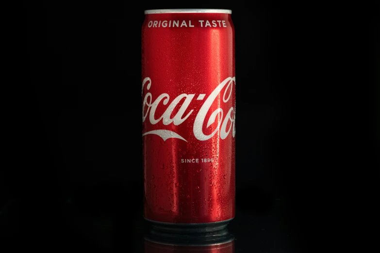 a red coca cola can that is sitting on a table