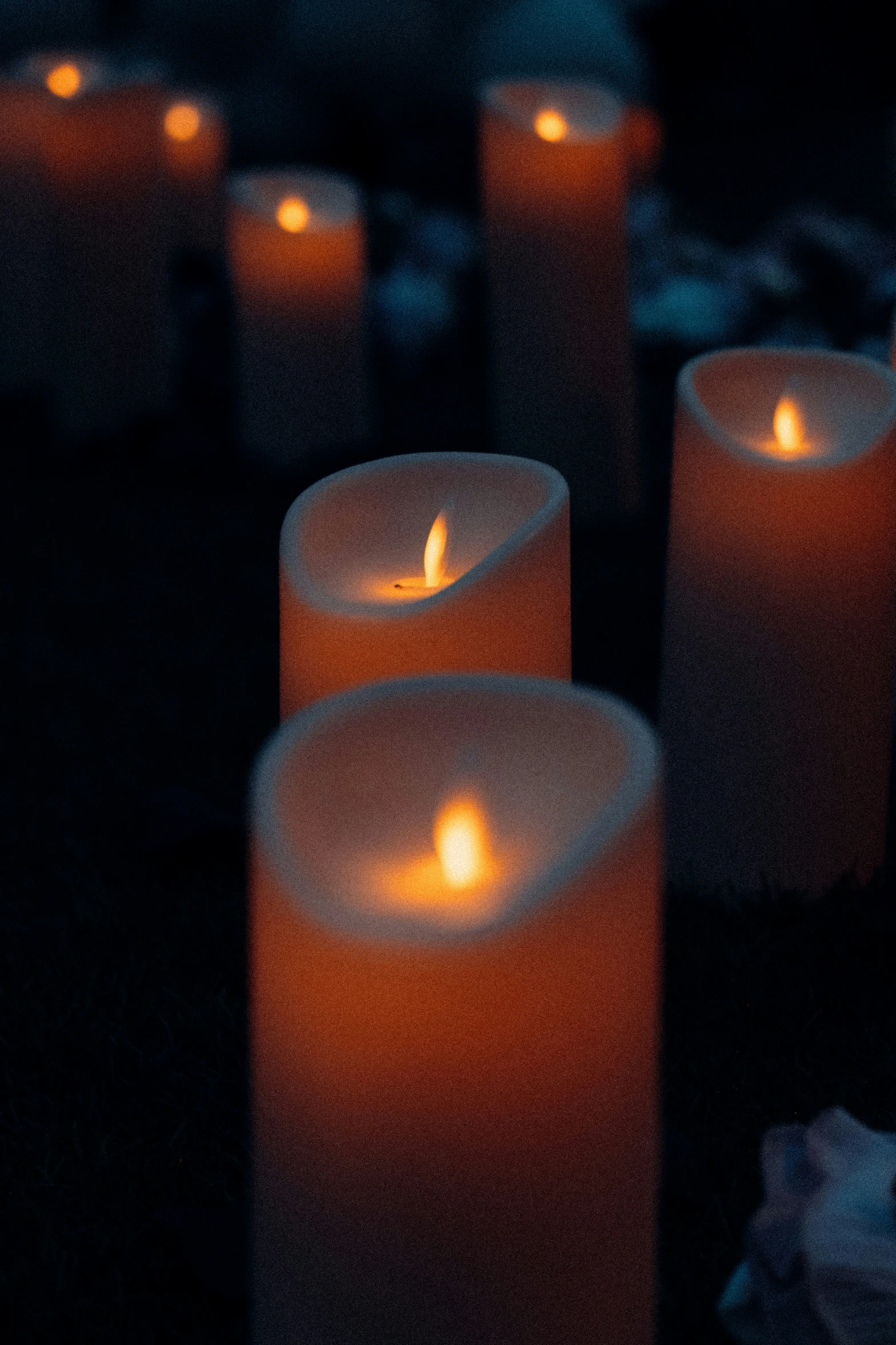 lit candles are on a black background