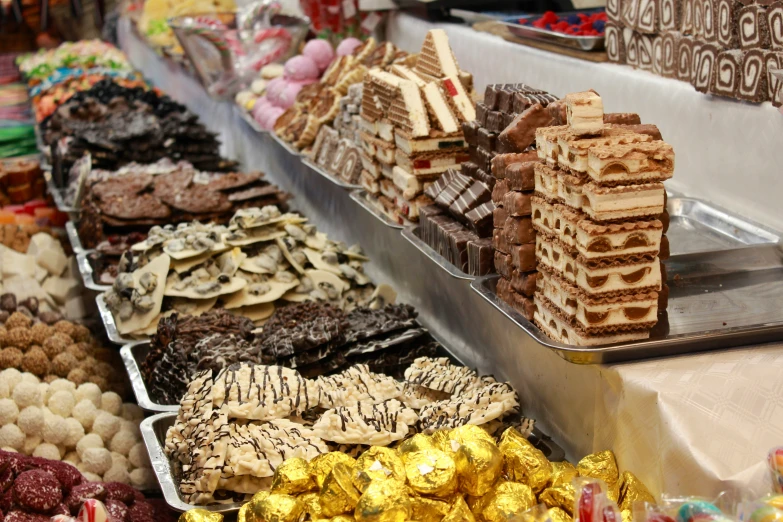 assortment of food displayed in serving trays at buffet