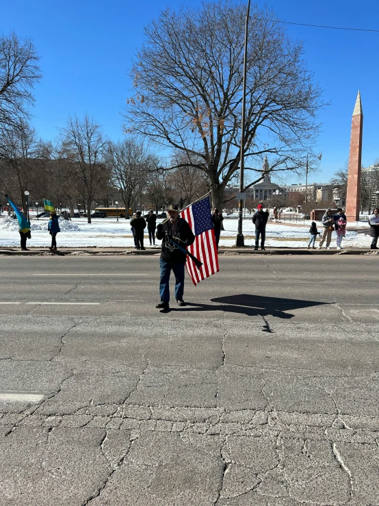 people standing in the street holding a flag