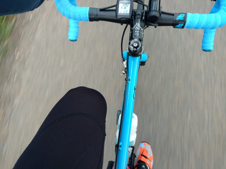 a person riding a blue bike on the street