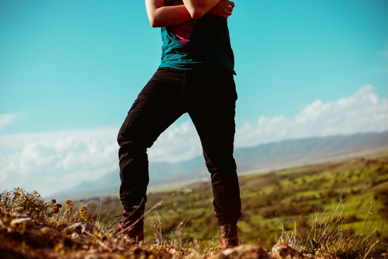 a young woman in the countryside stretching to take a swing