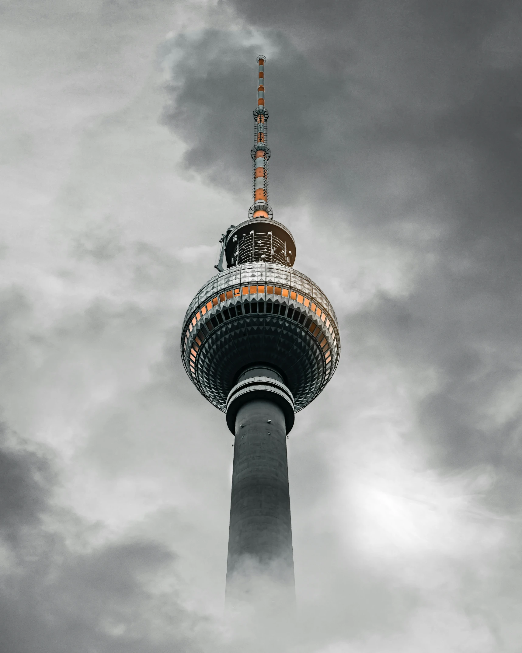 a very tall tower with a cloudy sky behind it