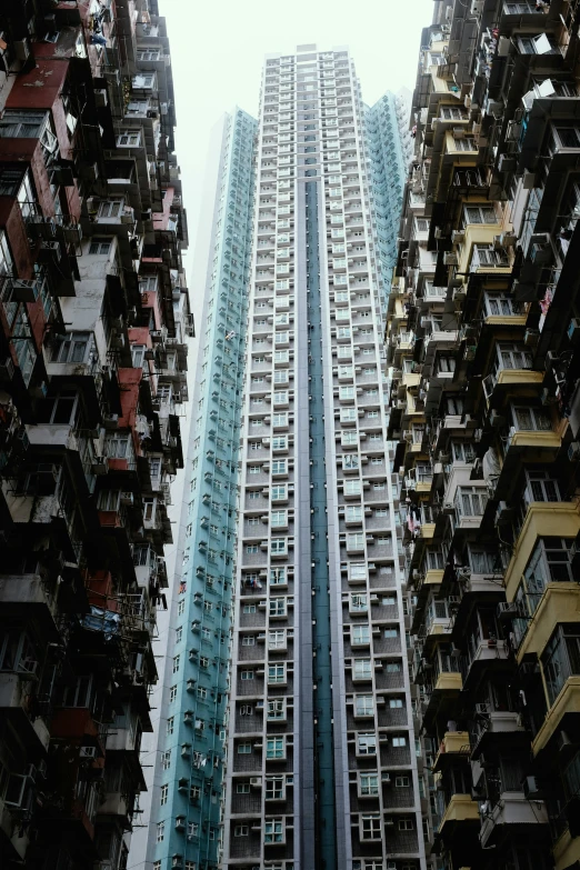 many windows, a balcony and balconies are on the sides of two high rise buildings